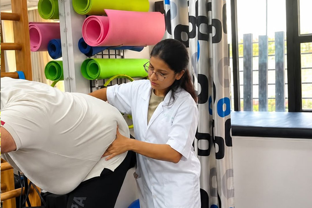 Physiotherapist guiding a patient through a shoulder mobility exercise